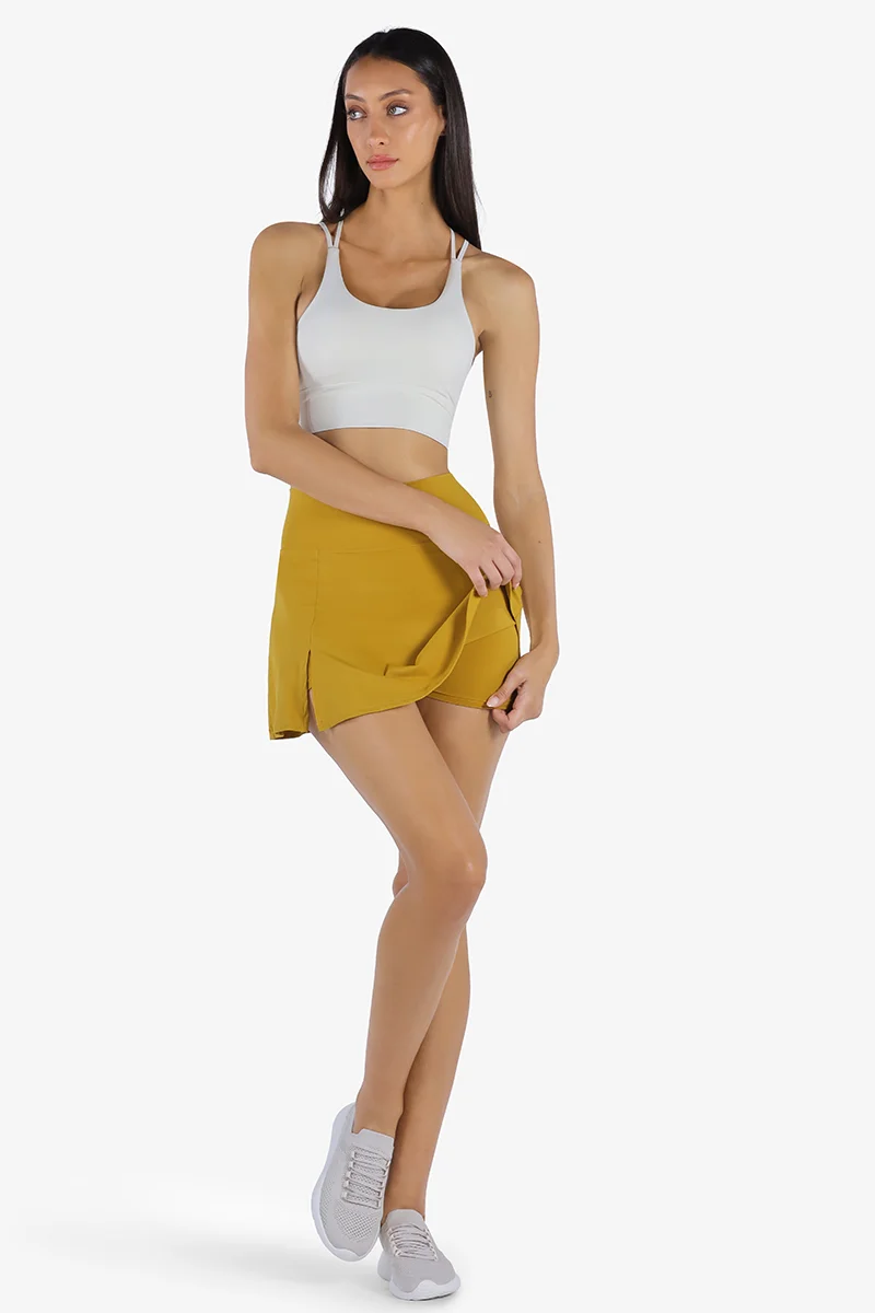 YesEco YesEco Women’s Activewear Set – White Padded Sports Bra & Mustard High-Waist Flared Skirt with Built-In Shorts – Sustainable Recycled Nylon