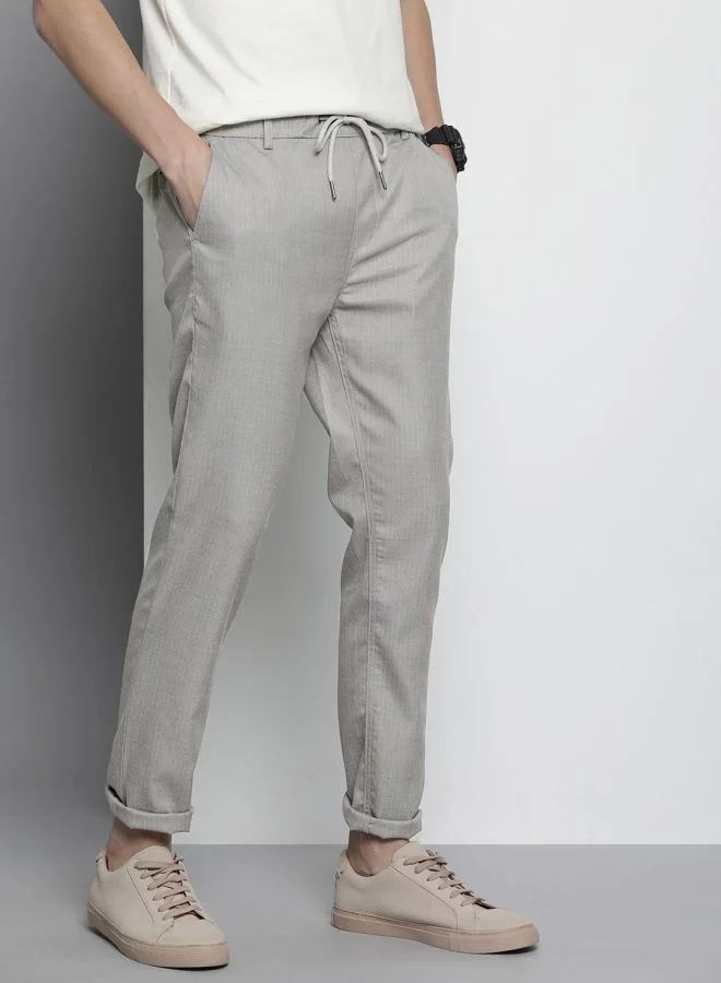 شركة المرآب الهندية Men Regular Fit Self Design Mid-Rise Stretchable Jogger Trousers