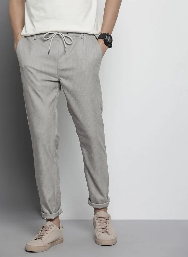 شركة المرآب الهندية Men Regular Fit Self Design Mid-Rise Stretchable Jogger Trousers