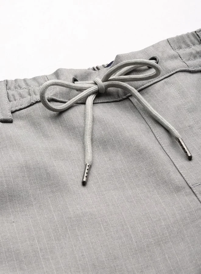 شركة المرآب الهندية Men Regular Fit Self Design Mid-Rise Stretchable Jogger Trousers