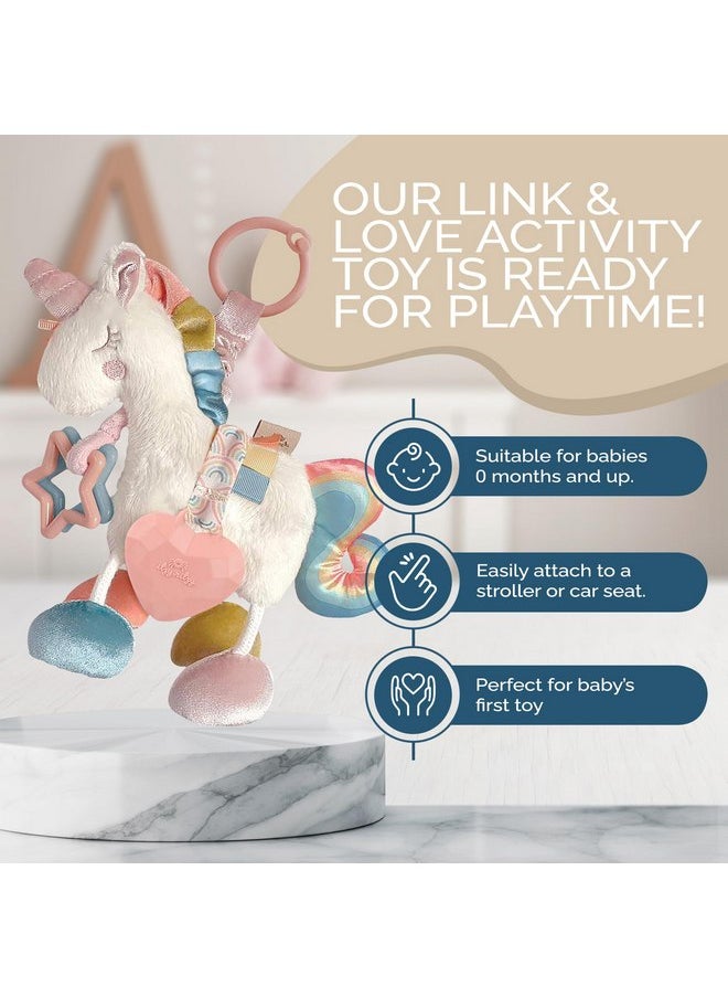 Itzy Ritzy - Itzy Ritzy Link & Love Toy for Stroller or Car Seat; Features Textured Ribbons, Crinkle Sounds, Clinking Rings & Silicone Teether; Designed For Ages 0 Months and Up (Unicorn) - Image 1