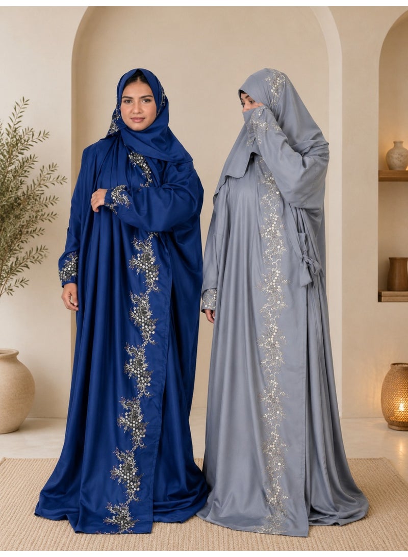 A two-piece women's prayer set featuring elegant embroidery and soft, comfortable fabric; it includes an attached head covering and a loose-fitting design that provides full coverage during prayer.
