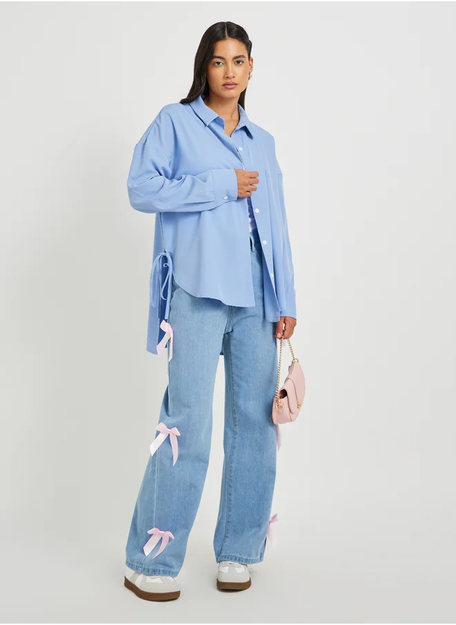ستايلي Solid Asymmetric Hem Oversized Shirt with Tie-Up Details