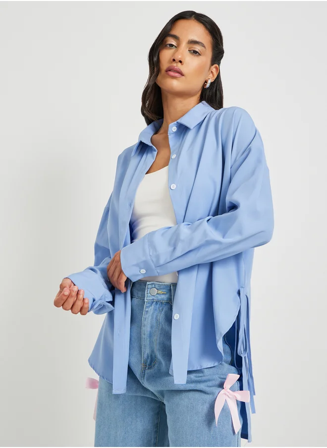 ستايلي Solid Asymmetric Hem Oversized Shirt with Tie-Up Details