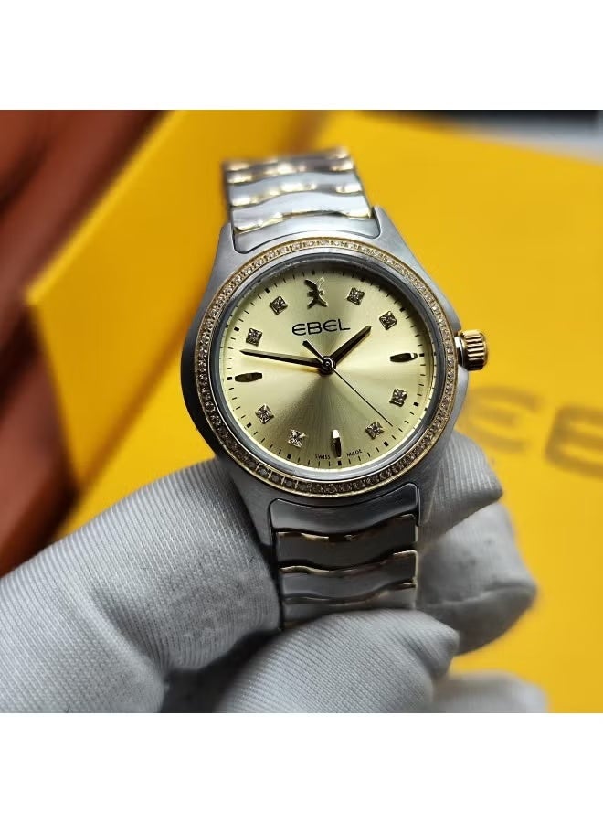 The Ebel women's watch features a classic design with a distinctive wave-shaped strap.