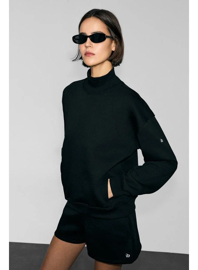 Urban Beat XENYA Women's Soft Polar Fleece Turtleneck Sweatshirt with Print Detail, Pockets and Regular Fit in Black.