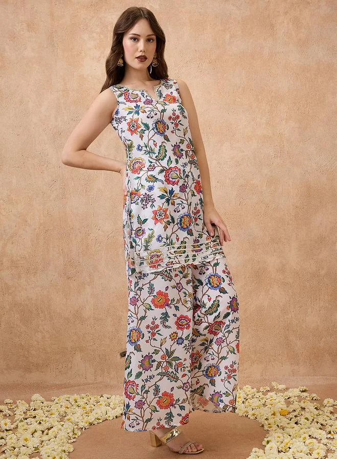 جلو باص طقم منسق من تونيك مطبع بالزهور وبنطال بالازو