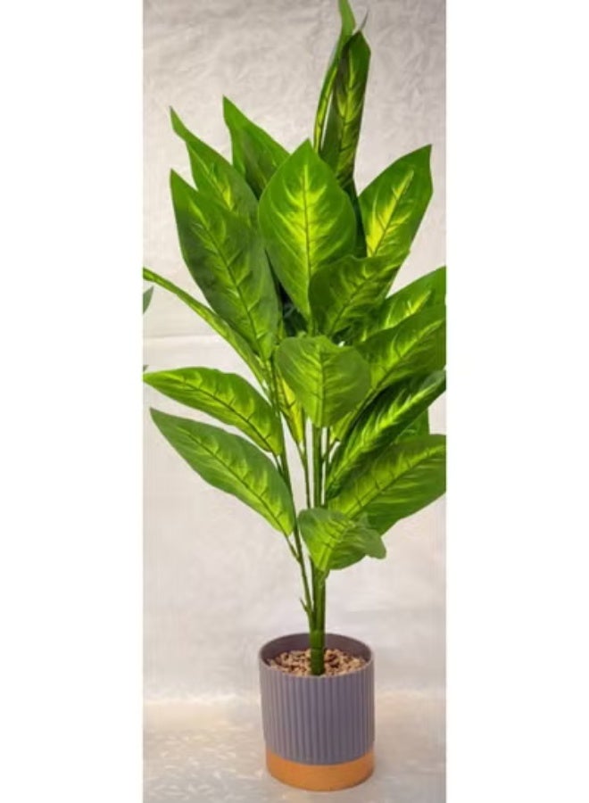 ناما نبات زينة صناعي وواقعي مثالي للديكورات الداخلية. يتميز بأوراق كبيرة وكثيفة باللون الأخضر الداكن والفاتح، مع عروق وتظليل يقلد مظهر نباتات الظل المعروفة مثل الديفنباخيا (Dieffenbachia) أو نباتات الأجالونيما (Aglaonema). بطول 80 سم - Image 1