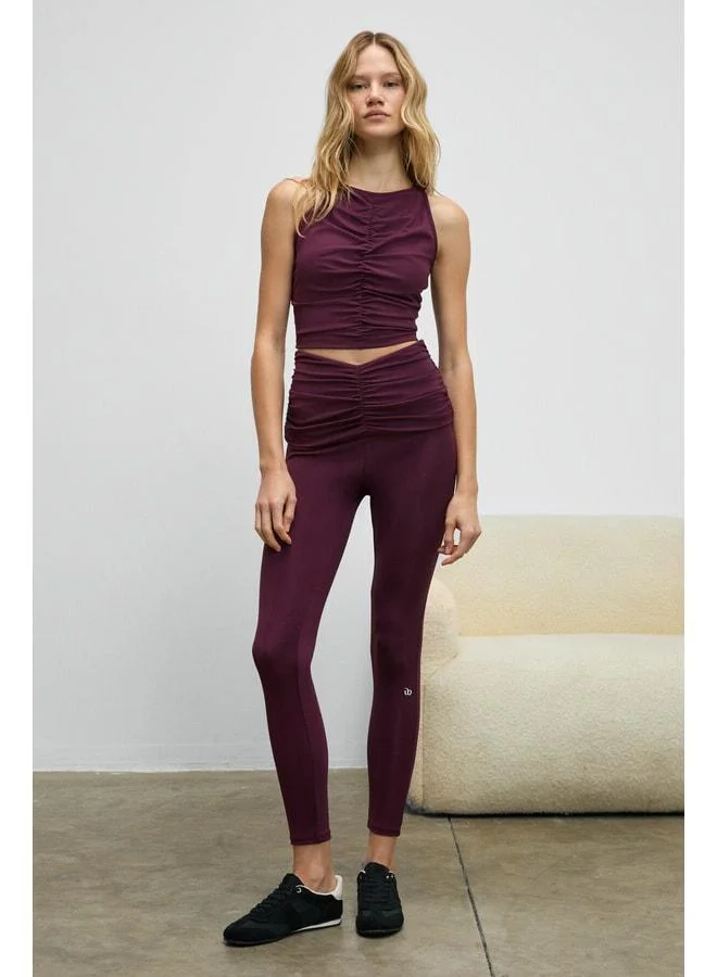 Urban Beat STRINVA Women's Stretchy and Soft-Textured Burgundy Leggings with Ruched Waist.
