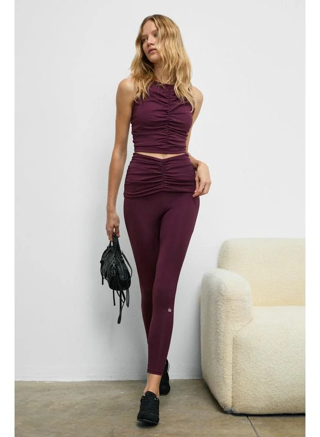 Urban Beat STRINVA Women's Stretchy and Soft-Textured Burgundy Leggings with Ruched Waist.