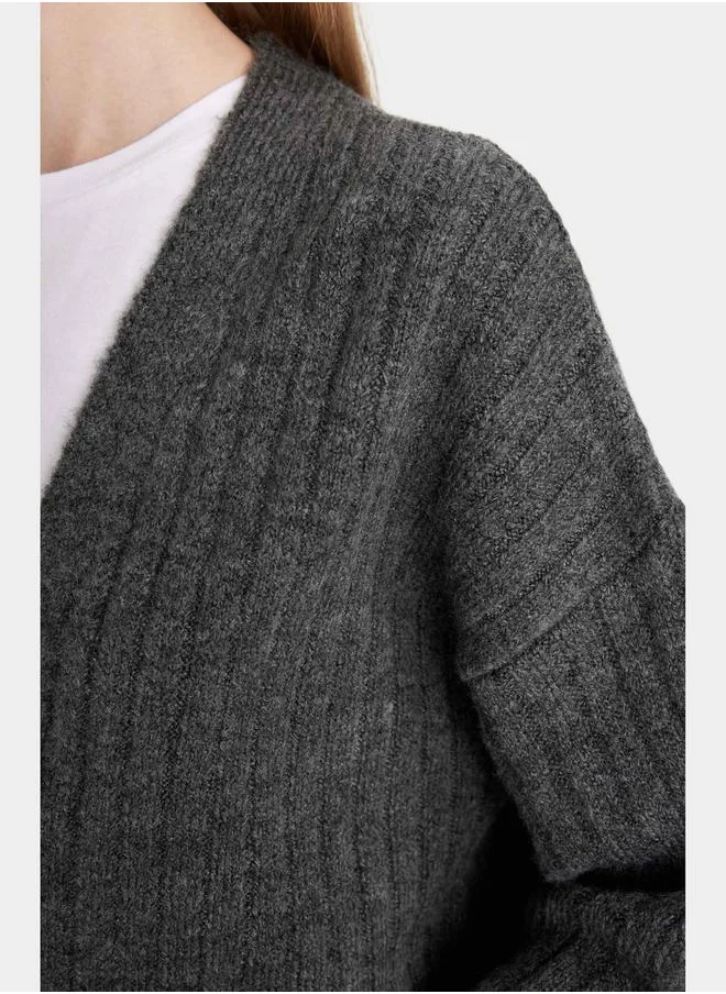 ديفاكتو Ribbed V Neck Oversized Crop Cardigan by Styli