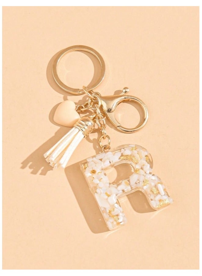 Gold color car key chain in the shape of the letter R