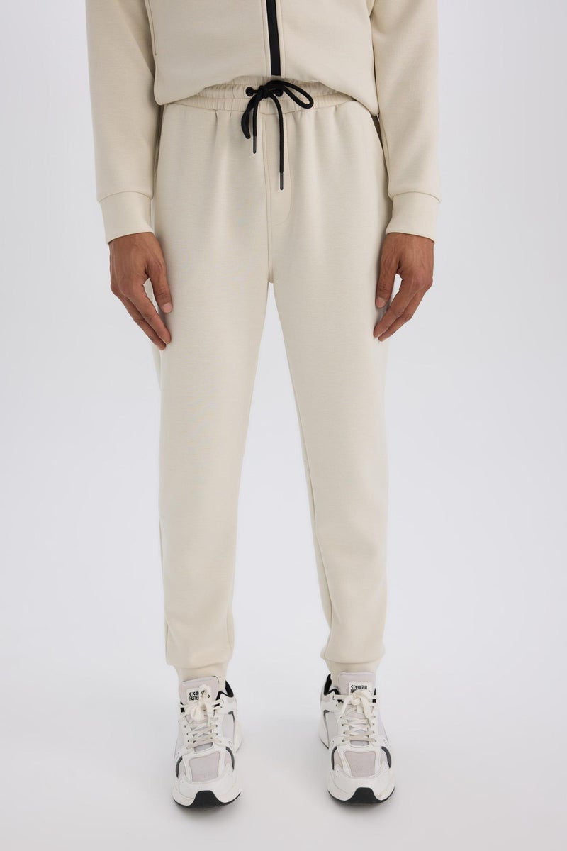 ديفاكتو بنطال رياضي رجالي DeFactoFit بقصة Slim Fit وساق قياسية من قماش سكوبا  - Image 1