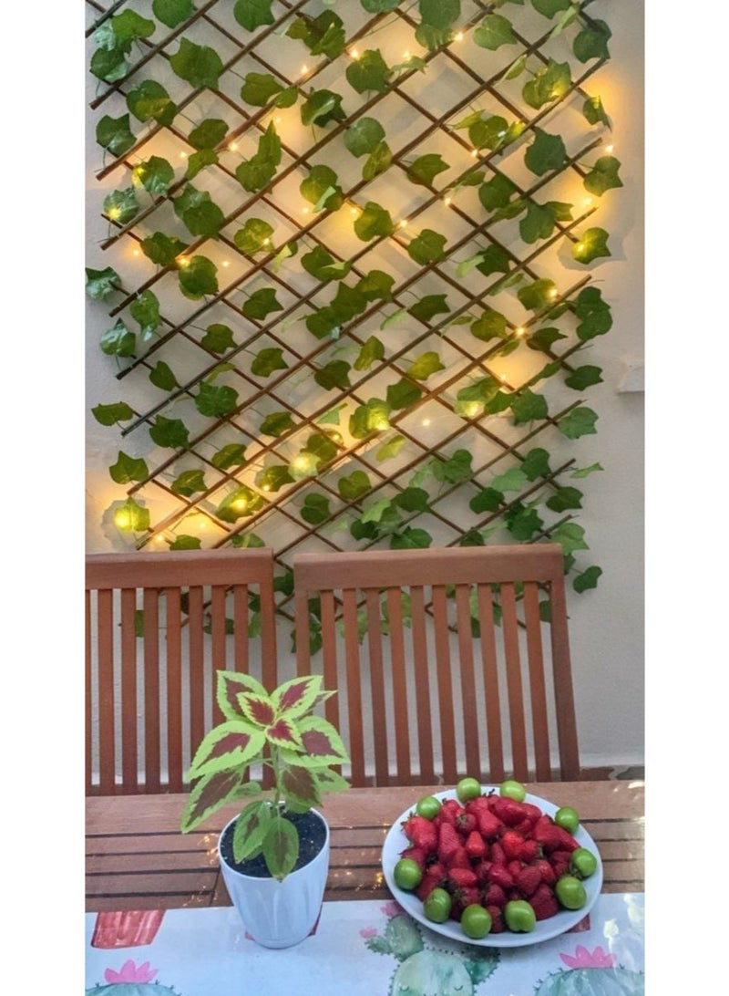 Leaf pergola 🌿 A wooden pergola with artificial flowers that can be hung from the house and balcony, on the fence, and on the wall, adding a touch of beauty. The product has a zipper, according to the size you prefer. It opens up to 2 meters and is 70 cm long. It is an imported product. Note: The product does not have lighting. - Image 1