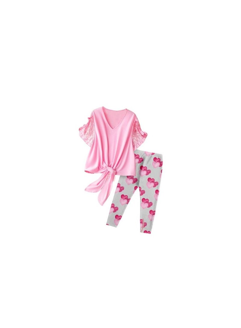 Summer women's pajama consisting of a pink T-shirt and gray pants with a drawing on it