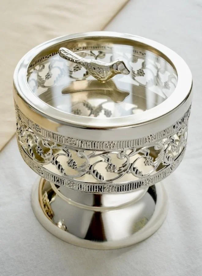 Casa Quesera Add a touch of vintage elegance to your home with this artisan silver-plated bowl, complete with a bird finial and decorative pedestal base. It's perfect for storing small treasures or displaying as a unique centerpiece.