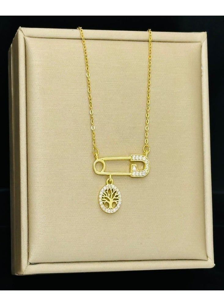 World Luxury Elegant gold necklace with a safety pin design and an inlaid tree of life. - Image 1