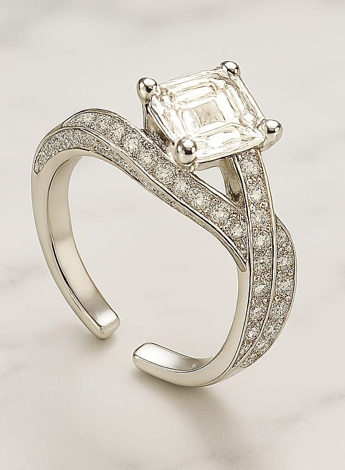 ""Aura of Luxury"" Ring - An Eye-Catching Design Shine an unforgettable look with this luxurious ring, which combines boldness and sophistication. A square-cut center stone sits atop an elegant base, surrounded by intricate details on the band, studded with tiny stones that add a subtle sparkle. Its distinctive design offers the perfect balance between luxury and modernity, making it a standout piece for every occasion." - Image 2