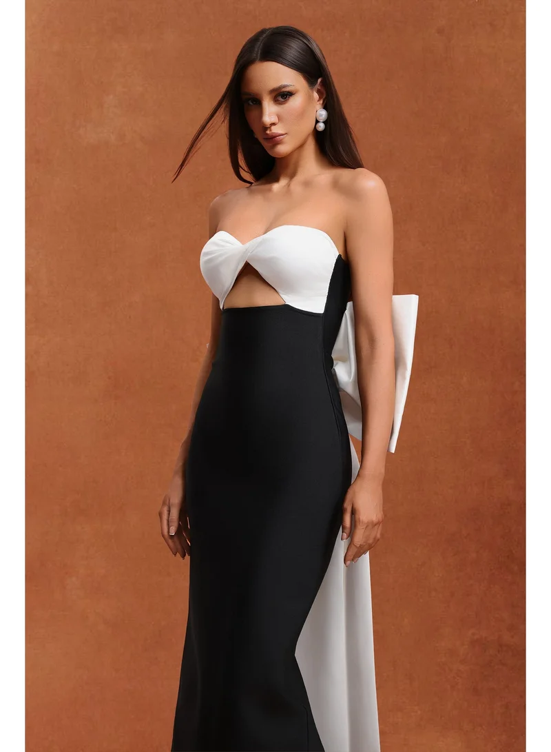 بيلا بارنيت فستان ماكسي بدون أكمام من رايدة بتصميم مزين بفيونكة وتفاصيل مفرغة.