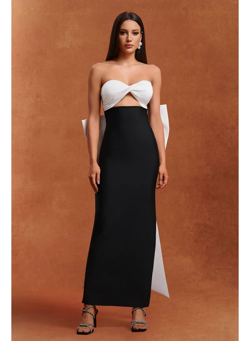 بيلا بارنيت فستان ماكسي بدون أكمام من رايدة بتصميم مزين بفيونكة وتفاصيل مفرغة.