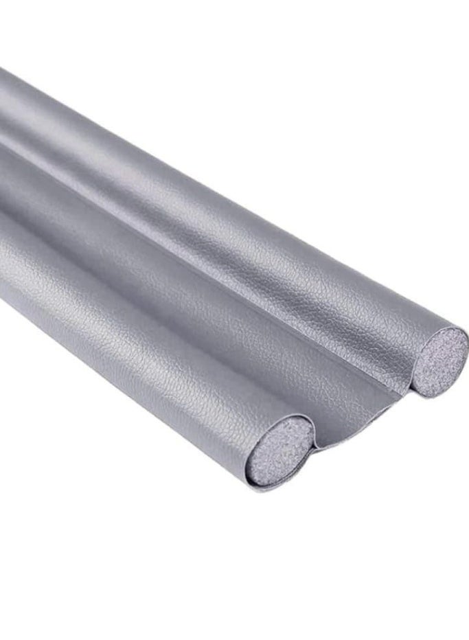 Keeping homes clean, quiet, and energy-efficient is made easy with this under-door draft stopper and insect blocker. Designed with a dual-insulation seal, it effectively blocks dust, wind, unwanted pests, and external noise while preventing air leaks to maintain optimal room temperature. Crafted from durable, highly flexible material, it glides smoothly across various floor surfaces without causing scratches. Featuring a customizable length that is easily trimmed to fit standard interior and exterior doors, it serves as a practical everyday solution for home protection. - Image 1