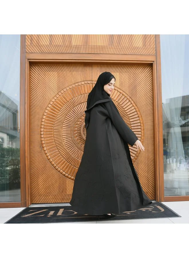 HAWRAA ABAYA Black wrap abaya made of rich fabric decorated with black embroidery and studs at the bottom with a button closure