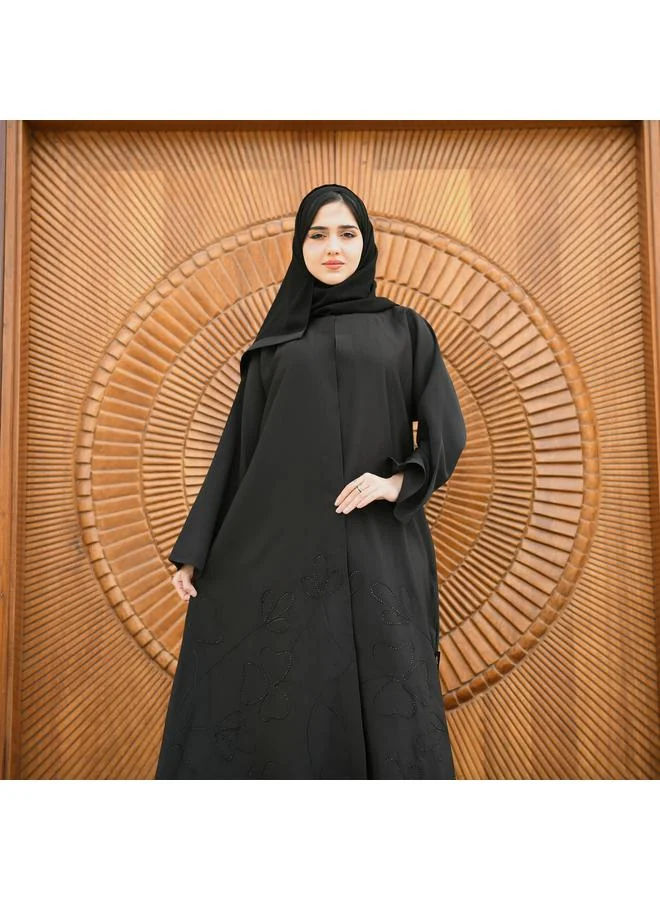 HAWRAA ABAYA Black wrap abaya made of rich fabric decorated with black embroidery and studs at the bottom with a button closure