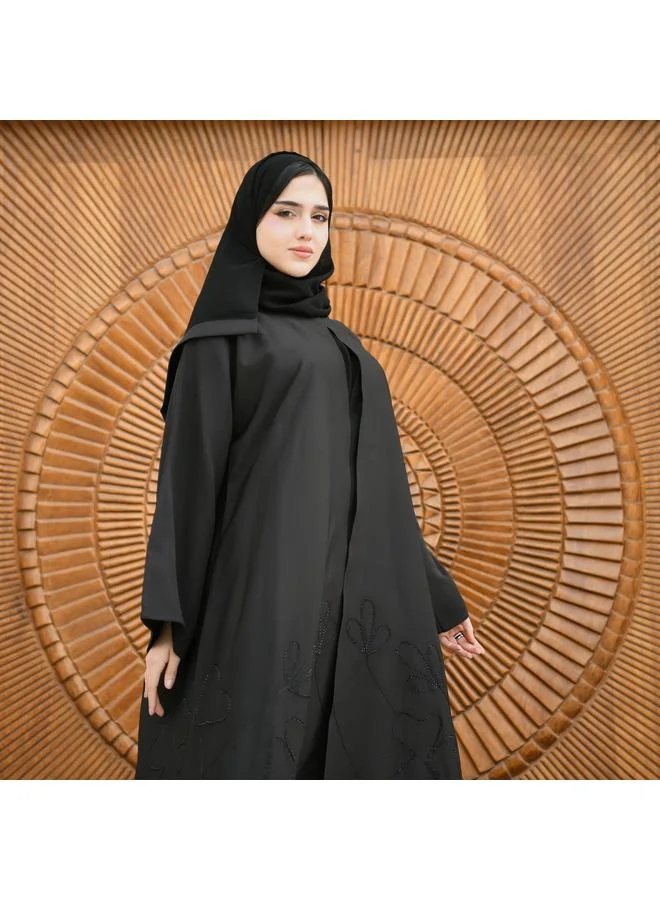 HAWRAA ABAYA Black wrap abaya made of rich fabric decorated with black embroidery and studs at the bottom with a button closure