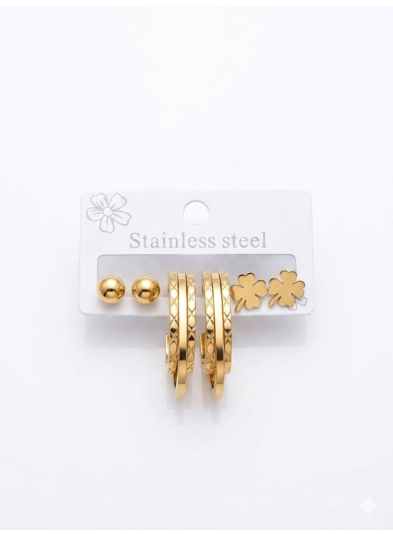 A charming golden earring set featuring delicate clover shapes and patterned hoops for a feminine and trendy look