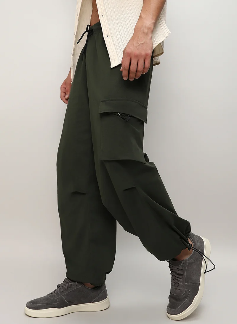Campus Sutra Men's Forest Green Solid Cargo Parachute Trousers