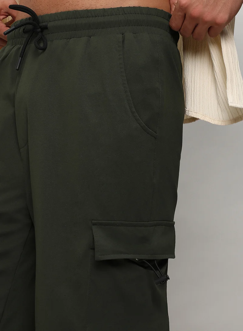 Campus Sutra Men's Forest Green Solid Cargo Parachute Trousers