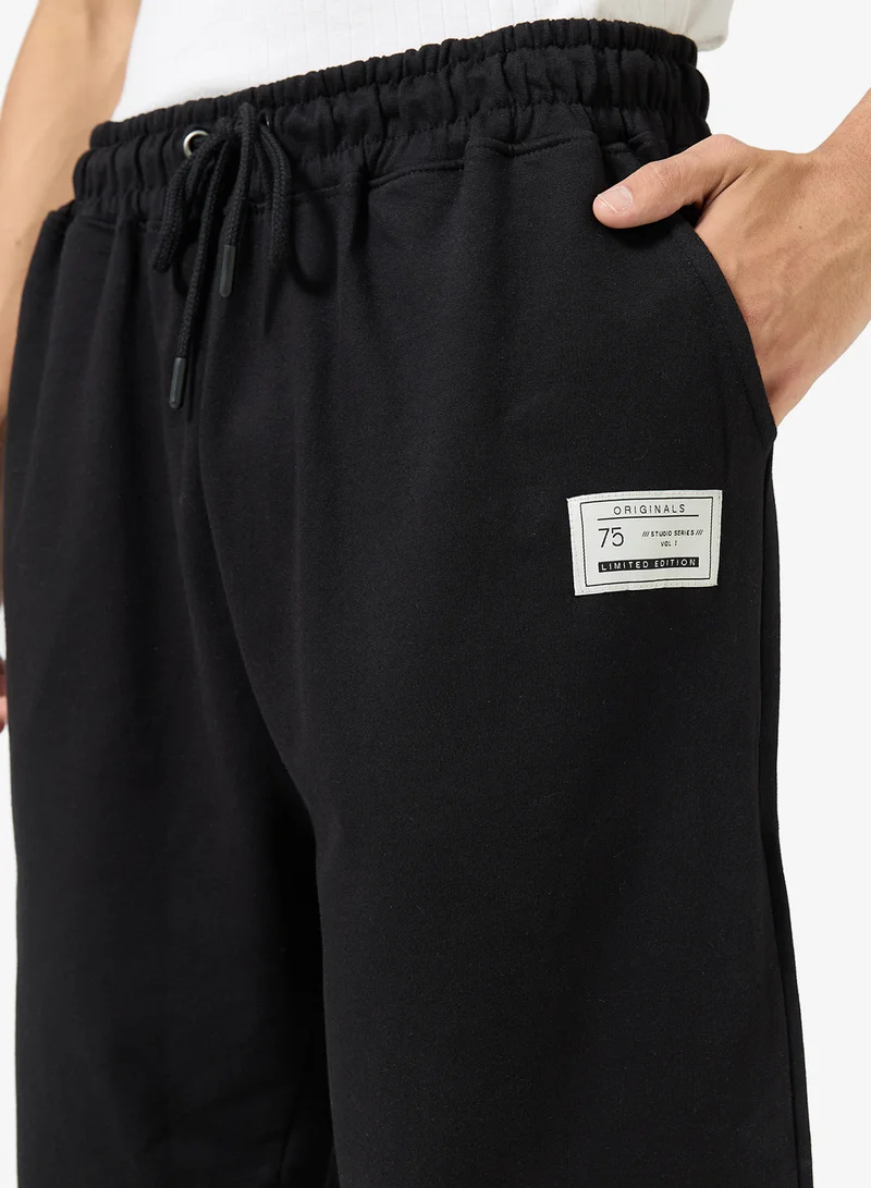 Seventy Five  Badge Detail Oversized Cuffed Joggers for Men | Best Price UAE