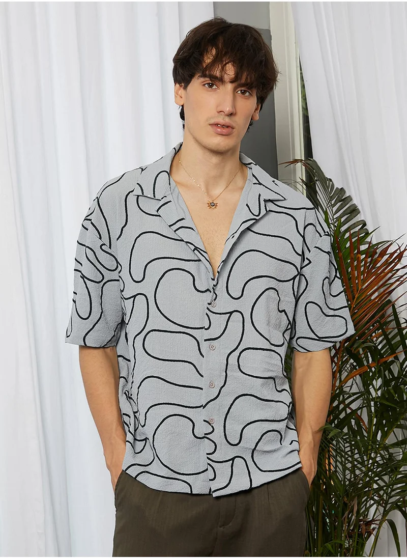 Campus Sutra Campus Sutra Men's Cloud Grey Abstract-Lined Oversized Shirt For Casual Wear | Cuban Collar | Short Sleeve | Button Closure | Oversized Shirt Crafted With Comfort Fit For Everyday Wear