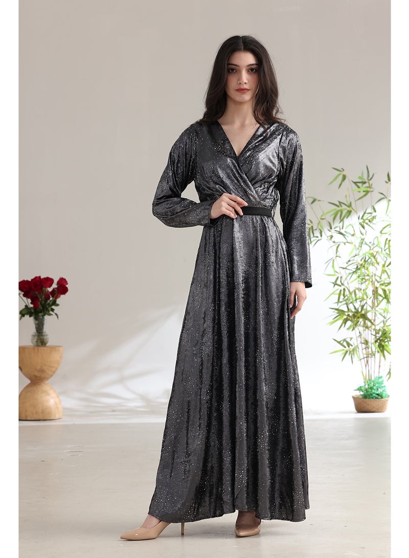 A long, shimmering evening dress with a wrap style and a waist belt. - Image 1