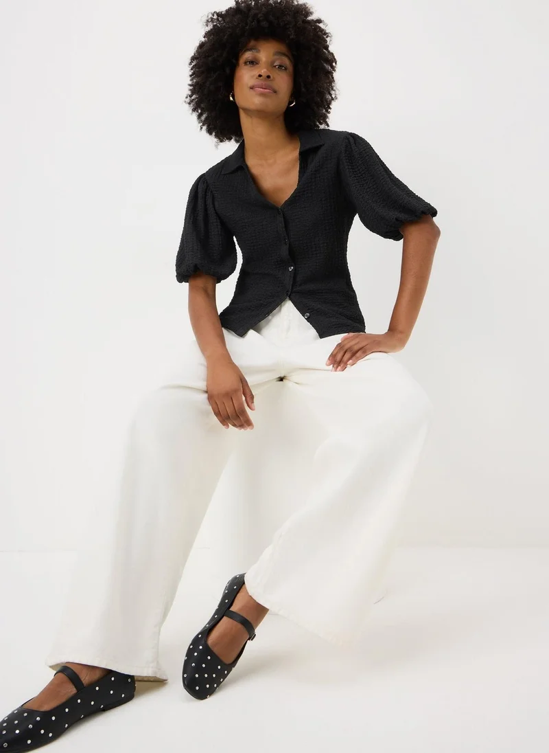 ماتلان قميص أسود بأكمام منتفخة وملمس مميز