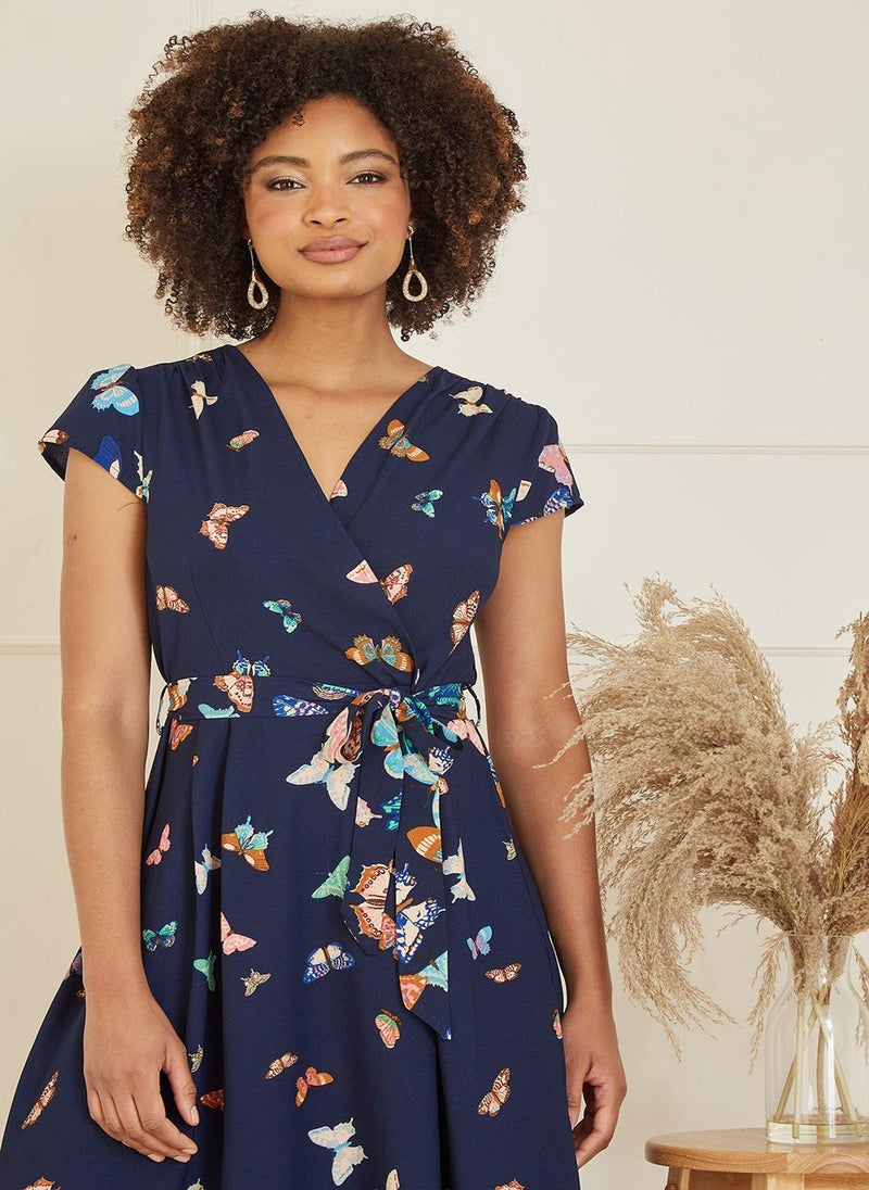 Yumi - Yumi Navy Butterfly Print Dip Hem Midi Wrap Dress - Image 1