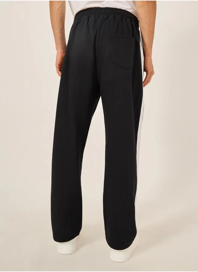 Styli Oversized Wide Tuck Fleece Joggers with Side Stripe and Print Detail
