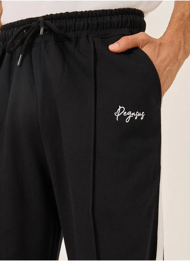 Styli Oversized Wide Tuck Fleece Joggers with Side Stripe and Print Detail