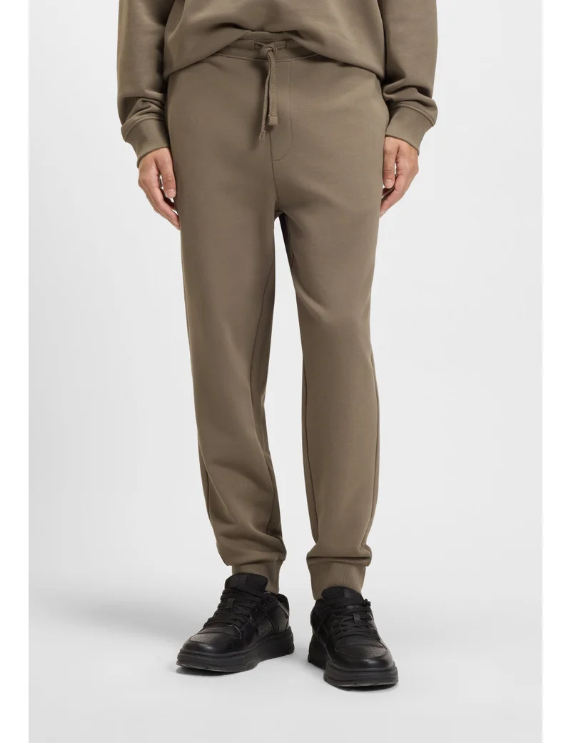 HUGO Cuffed tracksuit bottoms in cotton terry with logo print