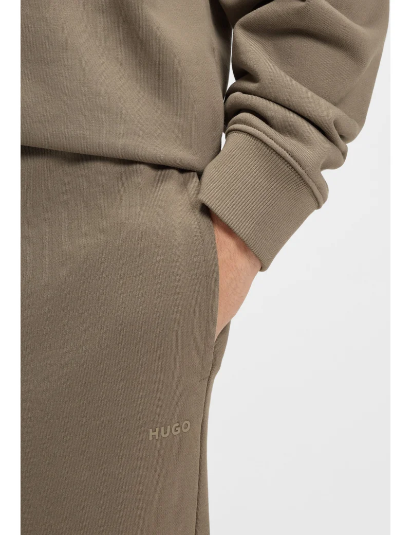 HUGO Cuffed tracksuit bottoms in cotton terry with logo print