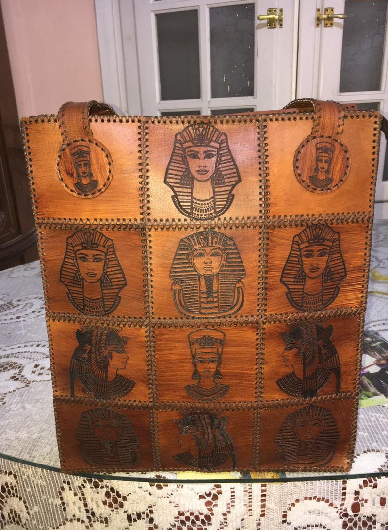 👜 Handmade Genuine Leather Shoulder Bag – Unique Pharaoh-Inspired Design 100% genuine leather – handcrafted with precision  Distinctive ancient Egyptian (Pharaonic) engravings  Large size for daily use or travel: 45×30 cm  2 main zippers for organized storage  Strong genuine leather shoulder straps  🛍️ Available now on Jumia & Noon From Holy of Holies Store – Where heritage meets style  - Image 1