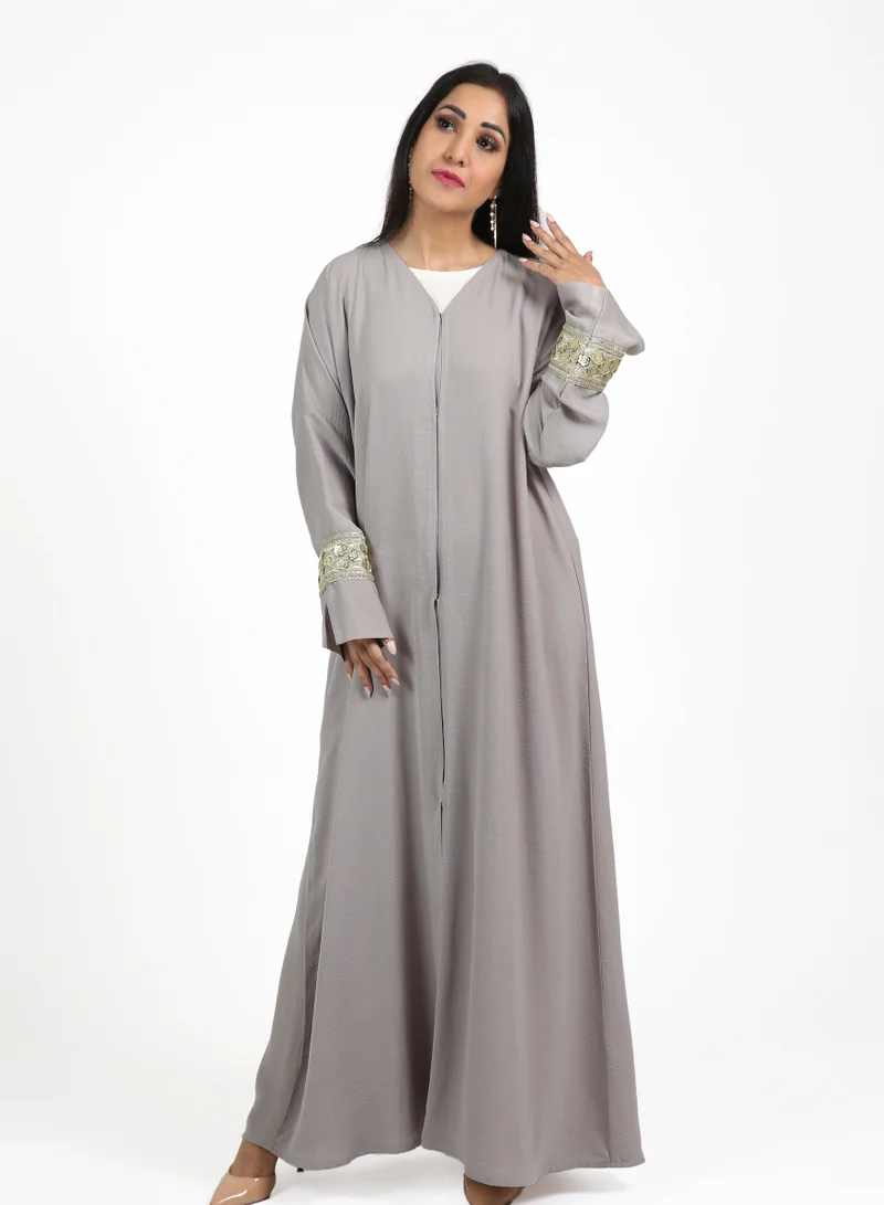 Nikias Hamriya crepe grey abaya with dull gold lace on sleeves