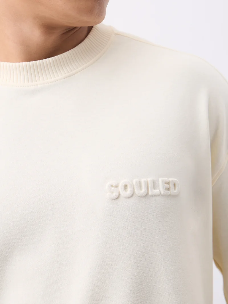 The Souled Store  The Souled Store Super-Oversized Tee: Caffeine Men and Boys Short Sleeves Round Neck Cream Solid Embossed Logo Super Oversized T-Shirts  | Best Price UAE