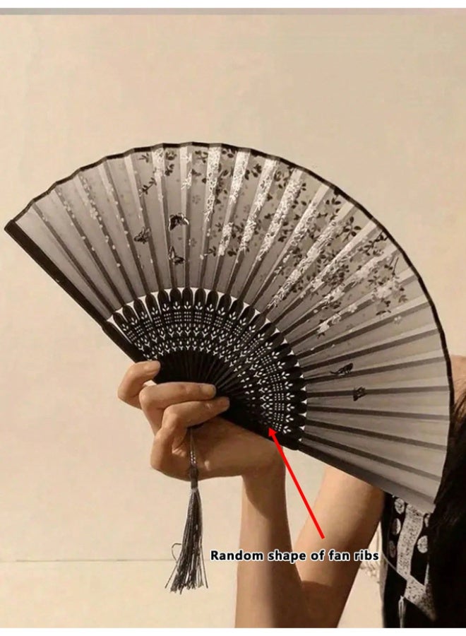 An elegant, foldable bamboo fan featuring a comfortable, handcrafted design; black with assorted floral patterns, and lightweight for portability. - Image 4