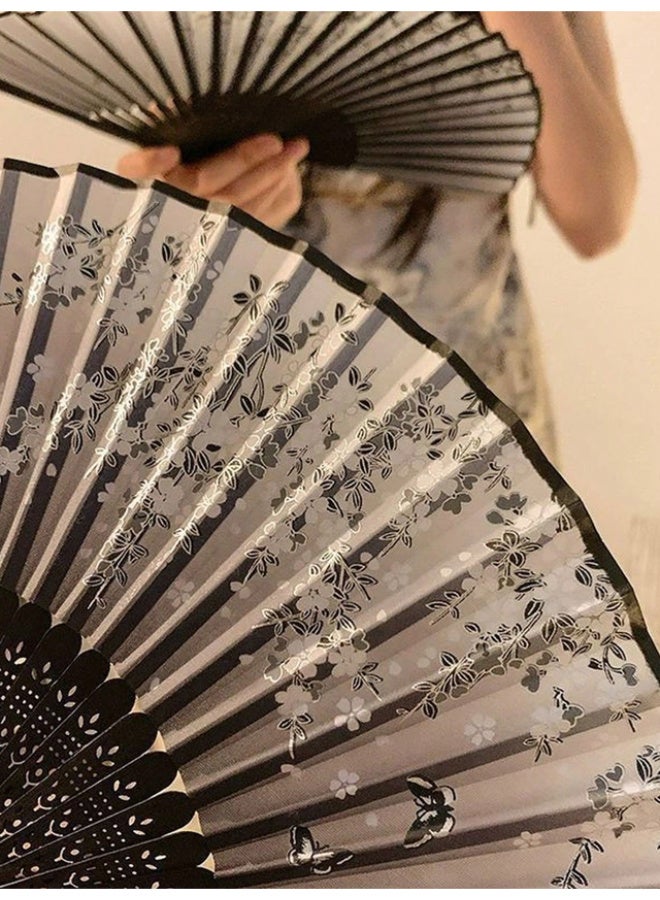 An elegant, foldable bamboo fan featuring a comfortable, handcrafted design; black with assorted floral patterns, and lightweight for portability. - Image 2
