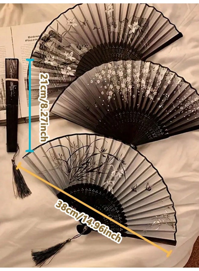 An elegant, foldable bamboo fan featuring a comfortable, handcrafted design; black with assorted floral patterns, and lightweight for portability. - Image 1