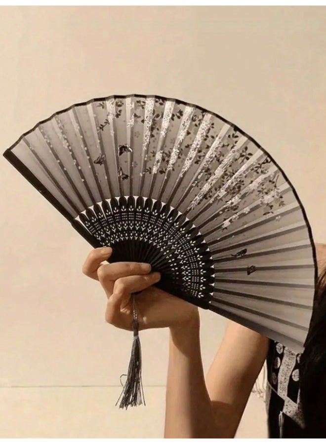 An elegant, foldable bamboo fan featuring a comfortable, handcrafted design; black with assorted floral patterns, and lightweight for portability. - Image 5