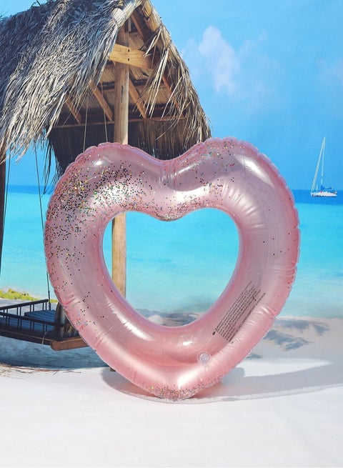 Pink heart-shaped swim ring with eye-catching inner glitter particles, perfect for summer parties, pools, and beaches. Swim ring size: 54×54 cm.