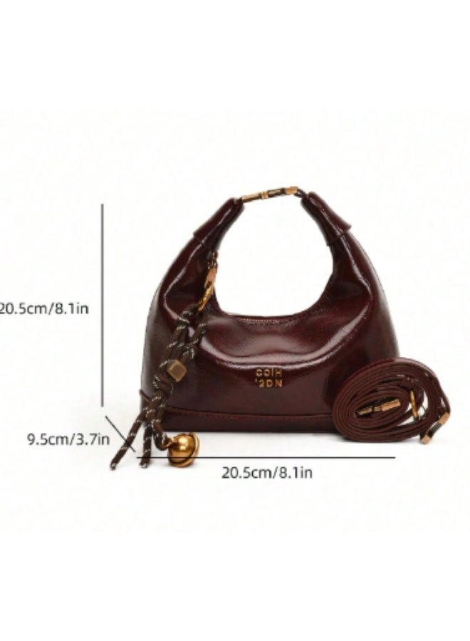 arab This mini women's shoulder bag features a glossy faux leather finish and a compact, elegant design – perfect for daily outings or special occasions. Comes in a rich burgundy color with a stylish tassel and gold-tone bell charm. Equipped with a secure top zipper and soft inner lining to protect your essentials.  Features:  Material: Glossy high-quality PU leather  Closure: Sturdy top zipper  Inner lining for added protection  Decorative tassel charm included  Lightweight and compact  Great for parties, dinners, and daily use  - Image 4