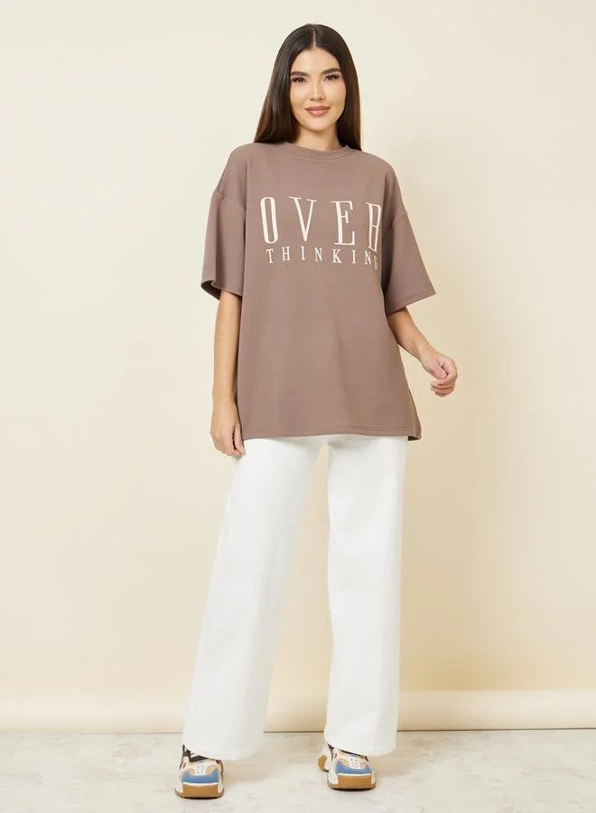 Styli Brown Oversized Contrast Slogan Print Textured T-Shirt for Women | Best Price UAE